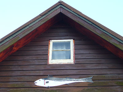 metal fish on clapperboard beach-house